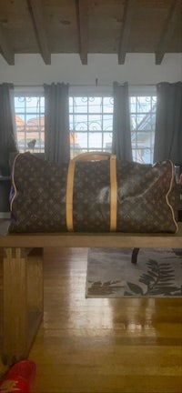 a louis vuitton bag sitting on a wooden table