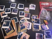 a table with a lot of polaroid photos on it