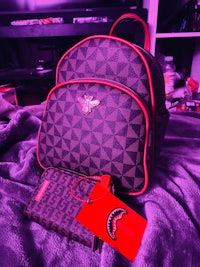 fendi bag and wallet on a purple blanket