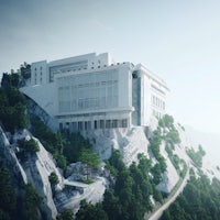 a white building sits on top of a mountain